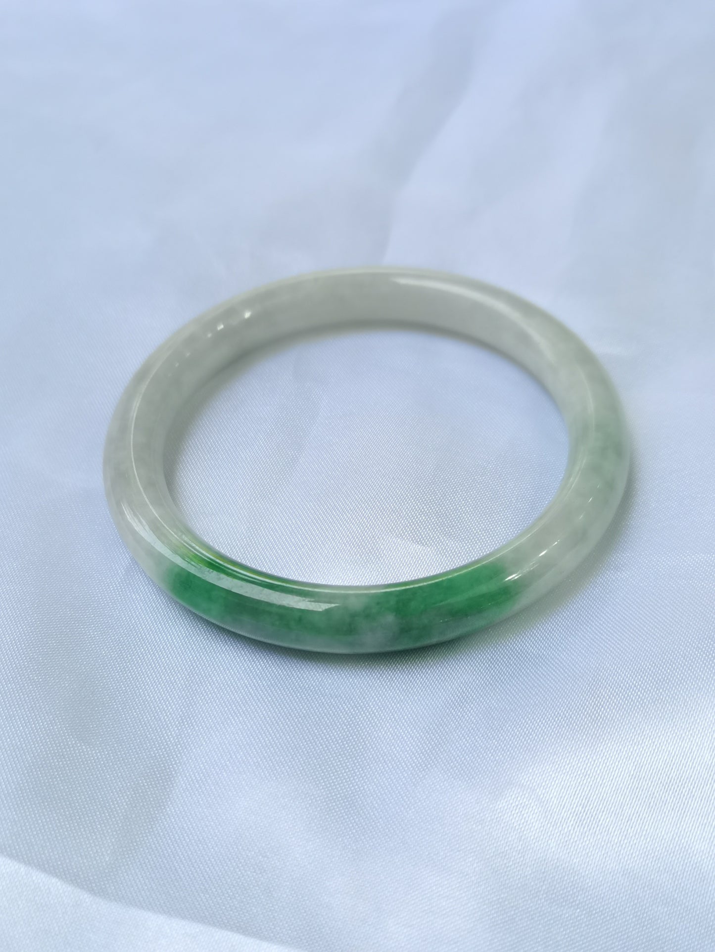 GUARDIAN | JAYDE Untreated Grade-A Jadeite Bangle in Dreamy White with patches of Vibrant Green (55.3mm Round)