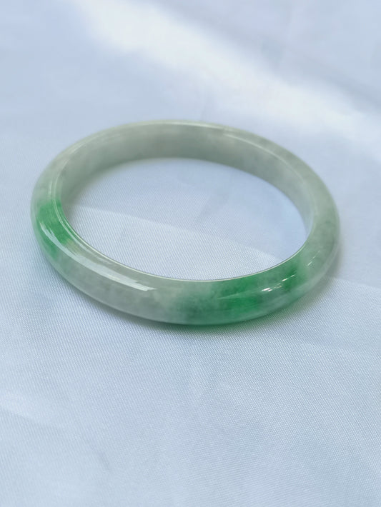 GUARDIAN | JAYDE Untreated Grade-A Jadeite Bangle in Dreamy White with patches of Vibrant Green (56.1mm Oval)
