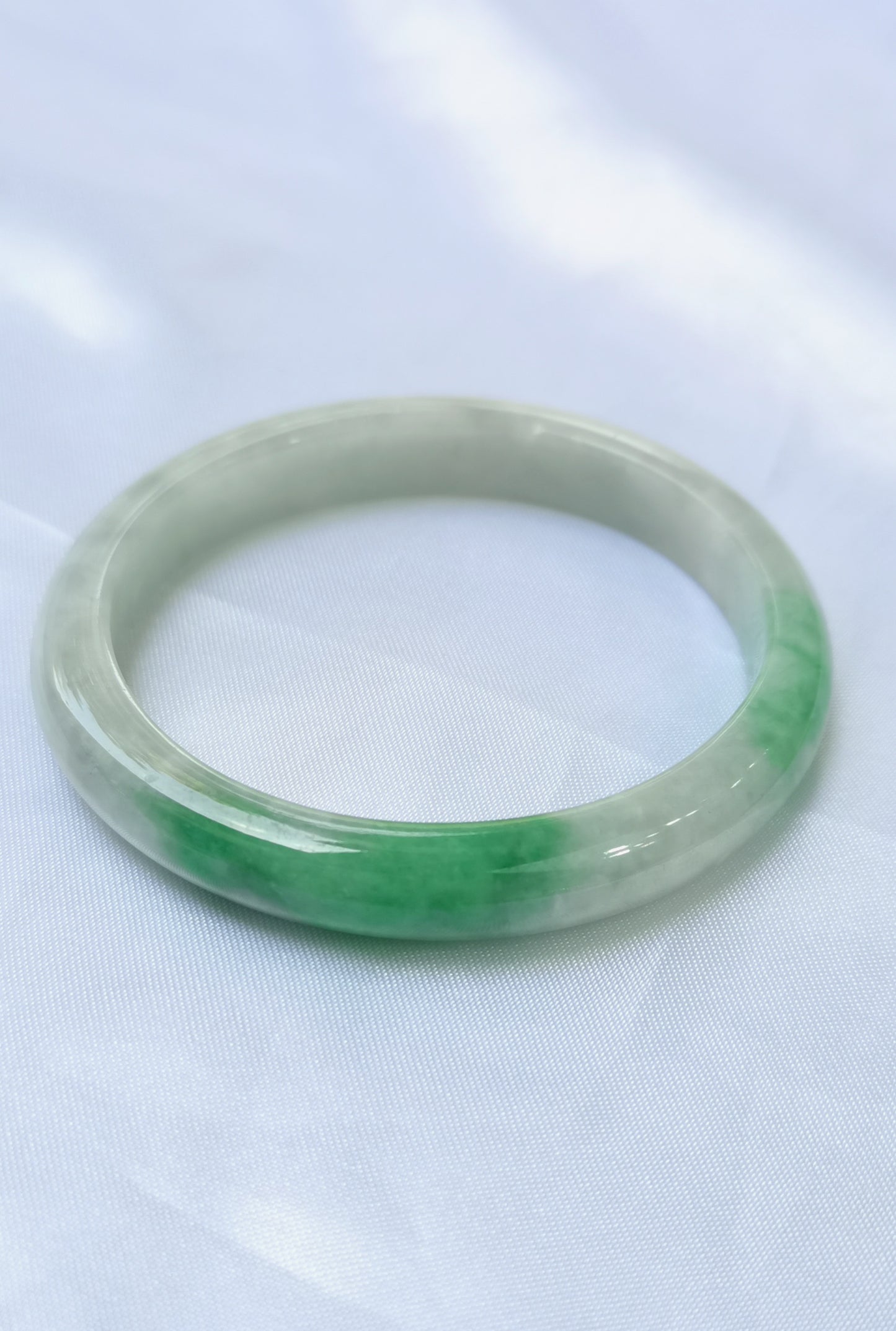 GUARDIAN | JAYDE Untreated Grade-A Jadeite Bangle in Dreamy White with patches of Vibrant Green (56.1mm Oval)