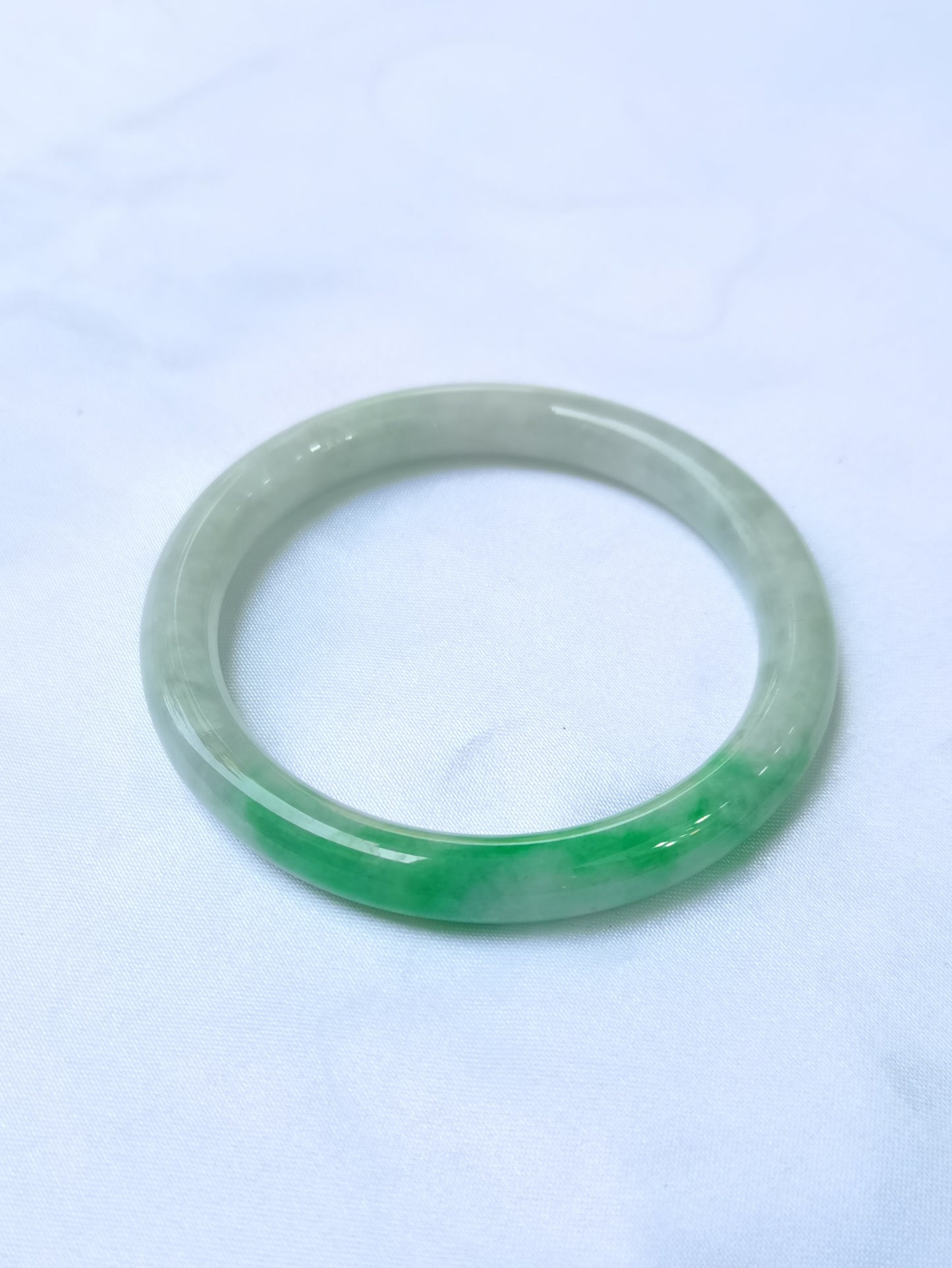 GUARDIAN | JAYDE Untreated Grade-A Jadeite Bangle in Dreamy White with patches of Vibrant Green (53.7mm Round)