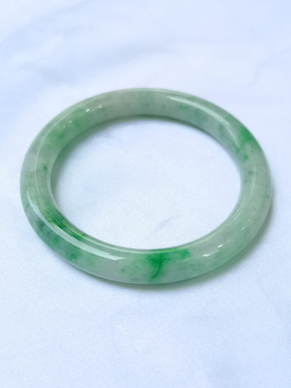 GUARDIAN | JAYDE Untreated Grade-A Jadeite Bangle in Pastel Green with patches of Vibrant Green (56.5mm Round)