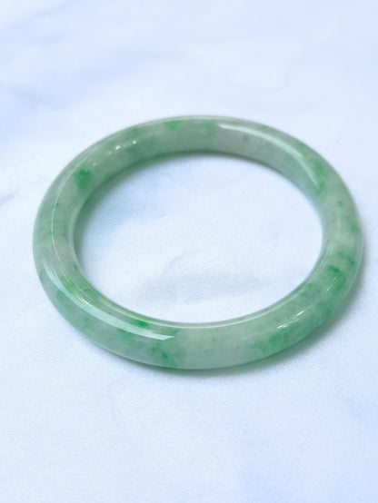 GUARDIAN | JAYDE Untreated Grade-A Jadeite Bangle in Pastel Green with patches of Vibrant Green (56.5mm Round)