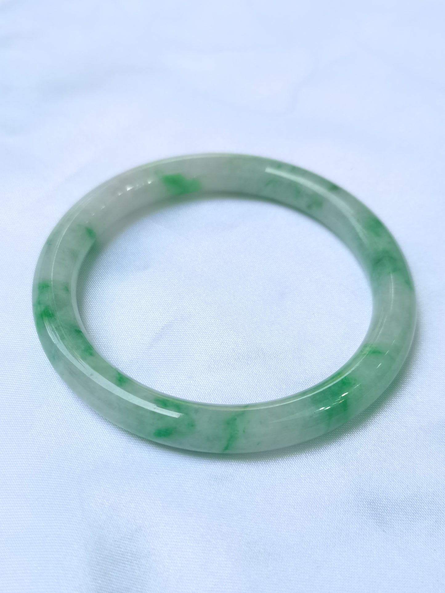 GUARDIAN | JAYDE Untreated Grade-A Jadeite Bangle in Pastel Green with patches of Vibrant Green (55.8mm Round)