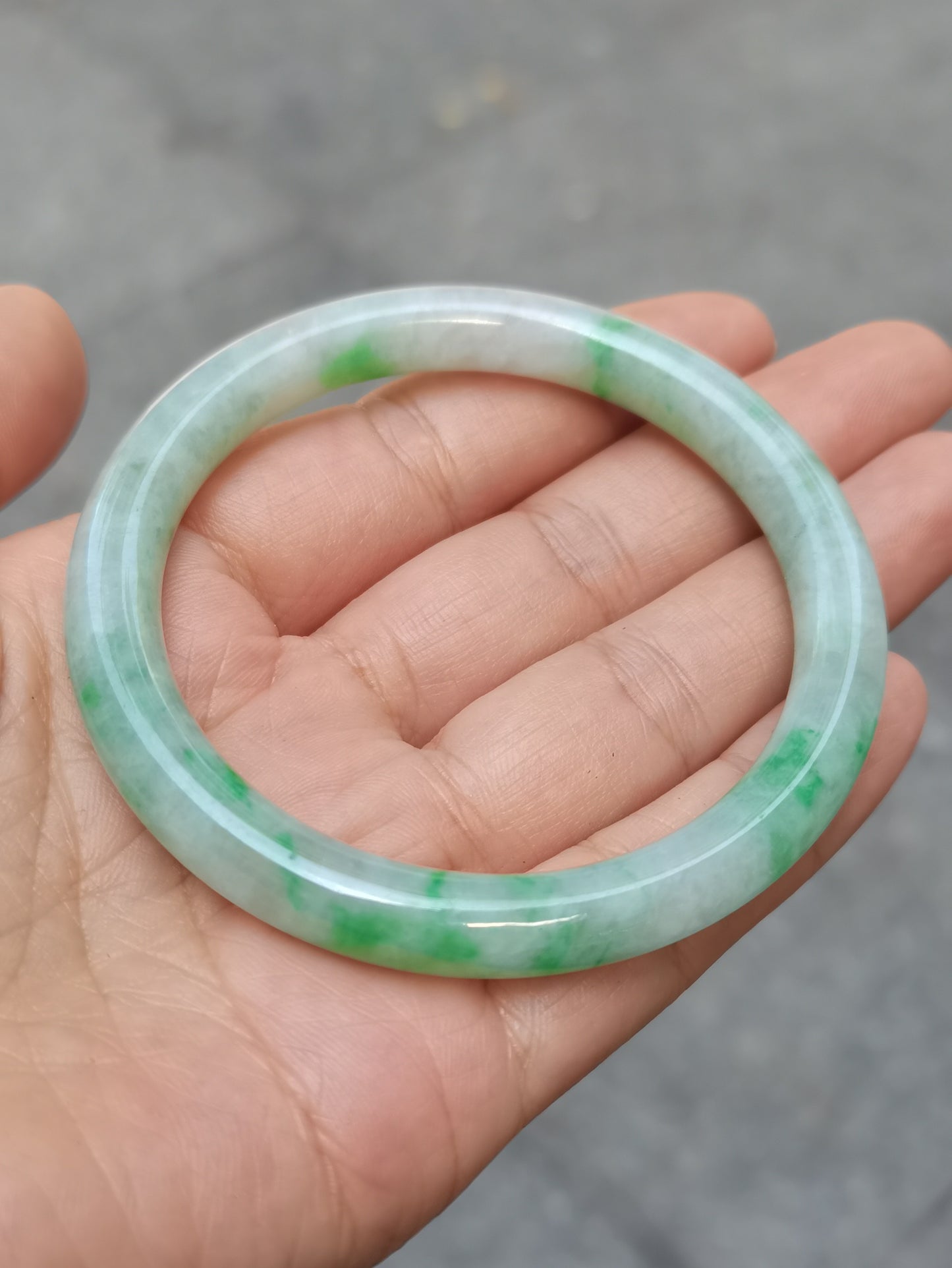 GUARDIAN | JAYDE Untreated Grade-A Jadeite Bangle in Pastel Green with patches of Vibrant Green (55.8mm Round)