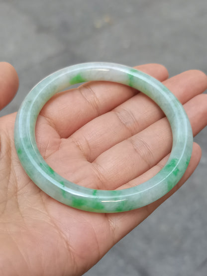GUARDIAN | JAYDE Untreated Grade-A Jadeite Bangle in Pastel Green with patches of Vibrant Green (55.8mm Round)