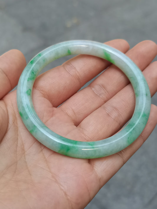 GUARDIAN | JAYDE Untreated Grade-A Jadeite Bangle in Pastel Green with patches of Vibrant Green (55.8mm Round)