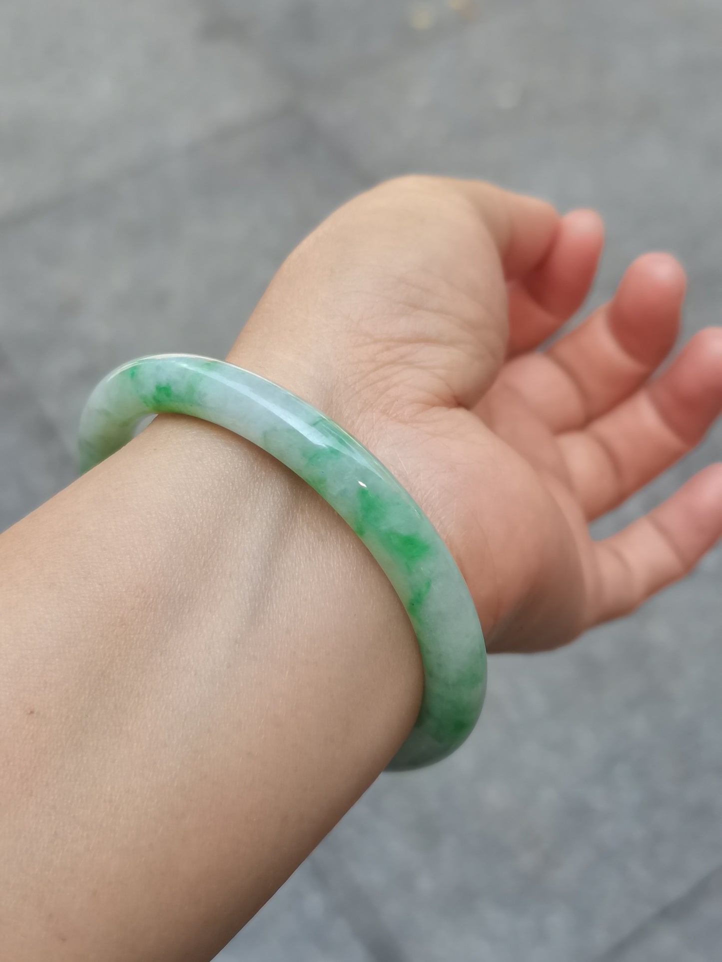 GUARDIAN | JAYDE Untreated Grade-A Jadeite Bangle in Pastel Green with patches of Vibrant Green (55.8mm Round)