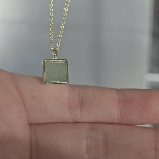 minimalistic modern simple green square shaped jadeite jade 14K gold vermeil pendant on asian mode under sunlight