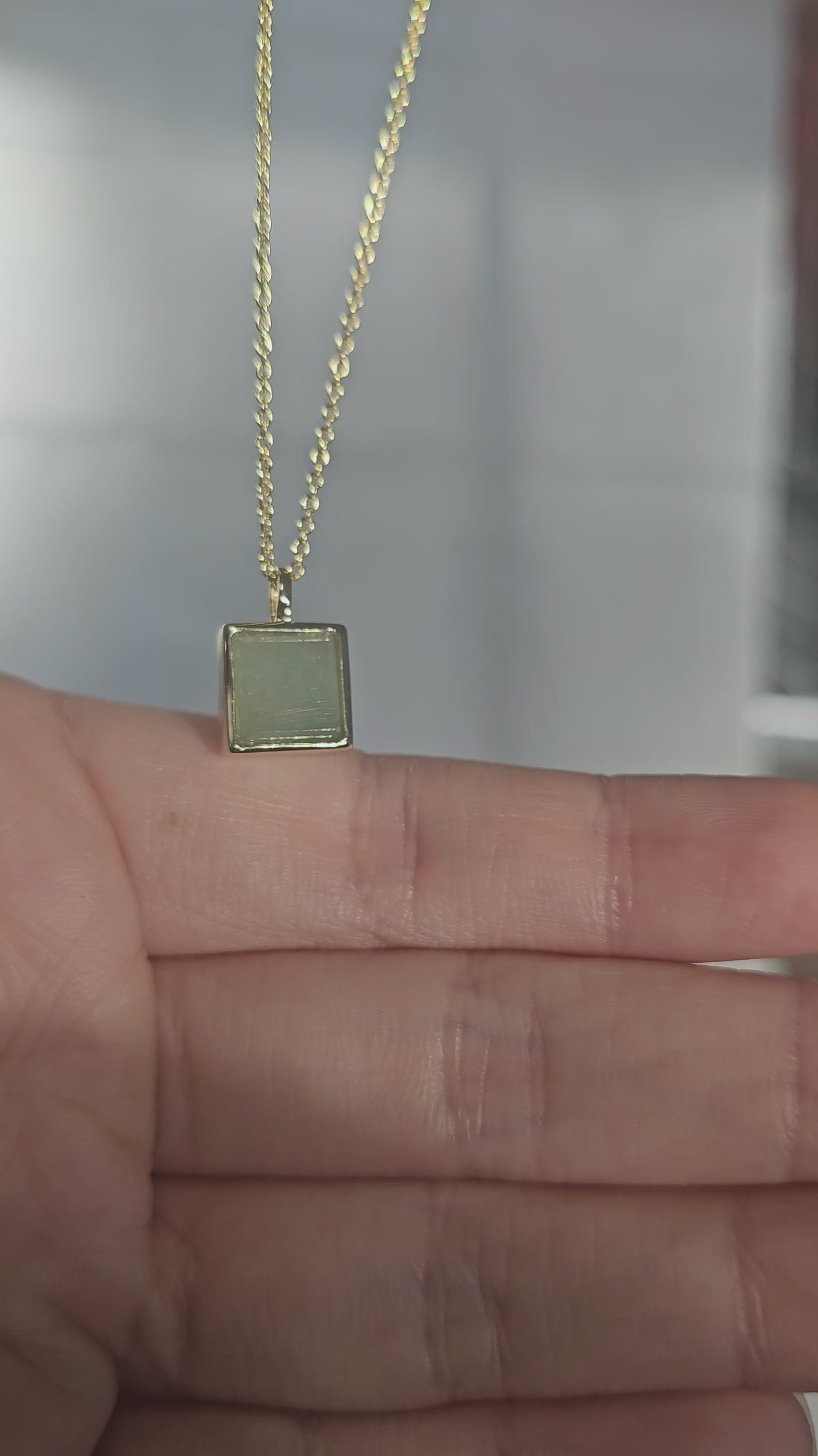 minimalistic modern simple green square shaped jadeite jade 14K gold vermeil pendant on asian mode under sunlight